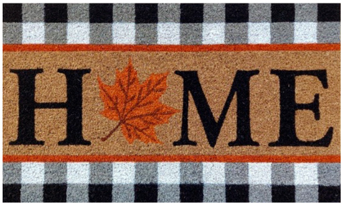 Doormat with 'HOME' text and a leaf design on a checkered background